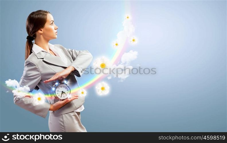 Businesswoman holding alarmclock. Image of young businesswoman holding alarmclock against illustration background