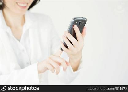 Businesswoman holding and using the mobile smart phone