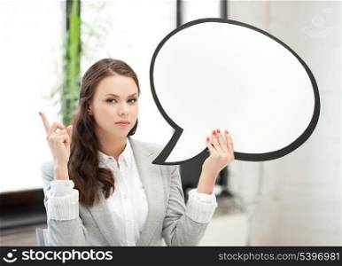businesswoman holding blank text bubble and pointing her finger up