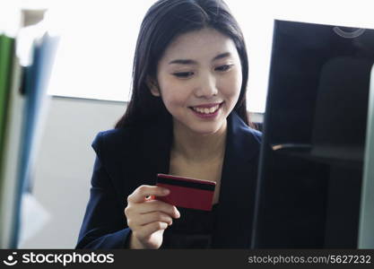 Businesswoman holding card in office