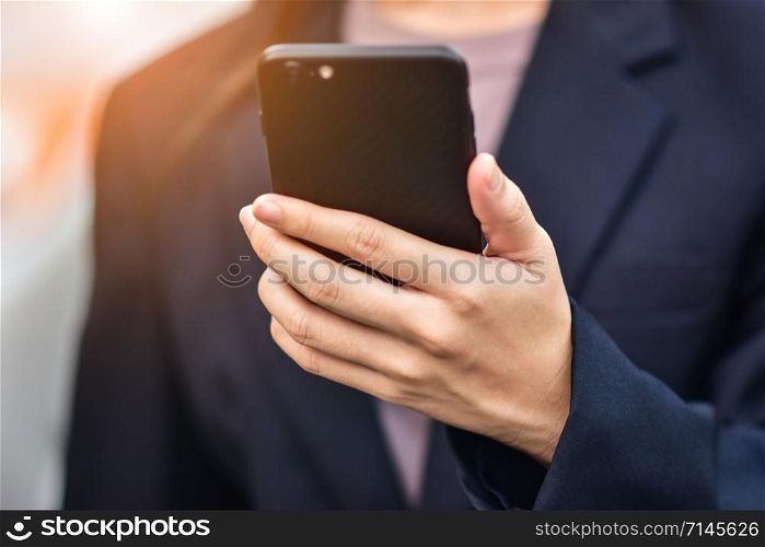 BusinessWoman holding cell phone using Mobile phone or Smart phone Telephone to call phone with Social media Icon technology by WiFi internet