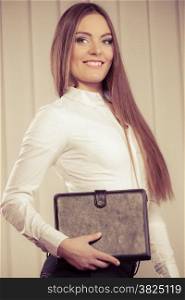 businesswoman holding document case. Elegant young woman blond girl with briefcase indoor. Corporate business. Sepia aged tone