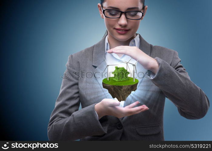 Businesswoman holding flying island in eco concept