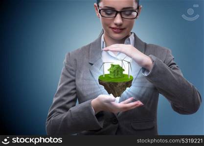Businesswoman holding flying island in eco concept