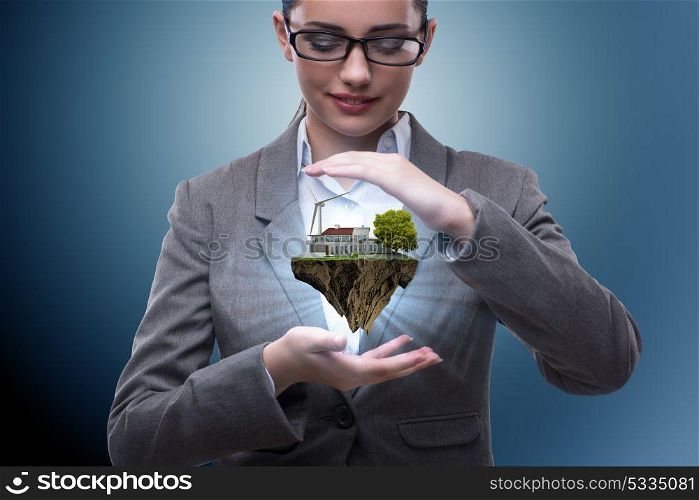 Businesswoman holding flying island in eco concept