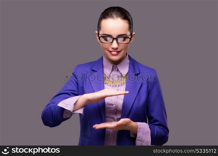 Businesswoman holding hands on gray background