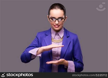 Businesswoman holding hands on gray background