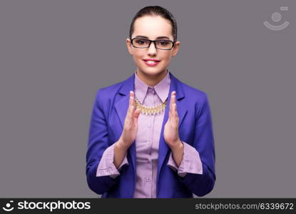 Businesswoman holding hands on gray background