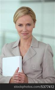 Businesswoman holding laptop