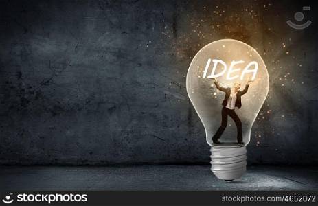 Businesswoman holding luminous idea inside light bulb. Creativity woman