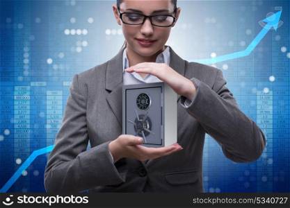 Businesswoman holding metal safe in security concept