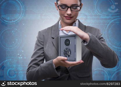 Businesswoman holding metal safe in security concept