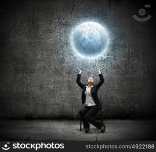 Businesswoman holding moon. image of businesswoman holding moon in hands above head