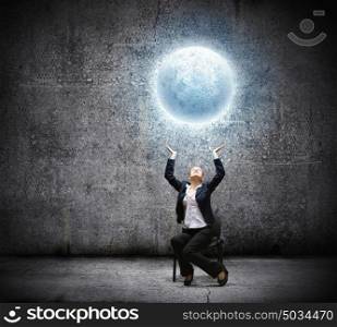 Businesswoman holding moon. image of businesswoman holding moon in hands above head