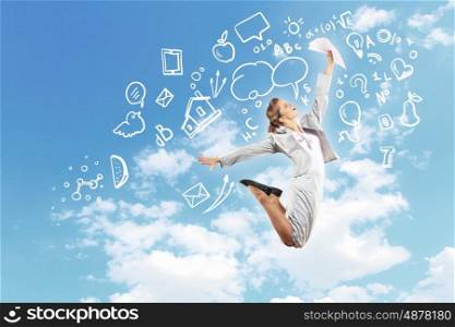 Businesswoman holding papers and jumping. Image of businesswoman in jump against clouds background