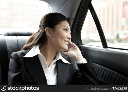 Businesswoman in a car on the phone