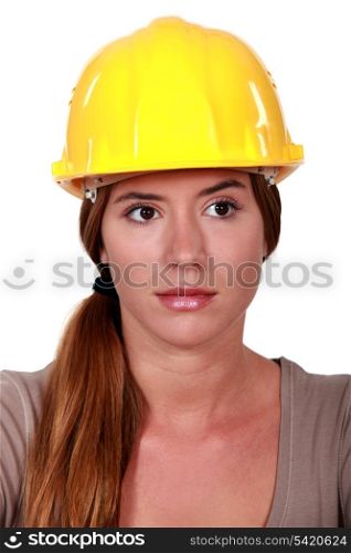 Businesswoman in a hardhat making a heart with her hands