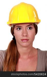 Businesswoman in a hardhat making a heart with her hands