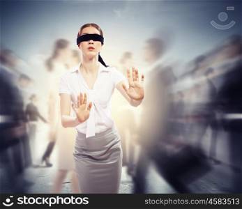 Businesswoman in blindfold among group of people. Image of businesswoman in blindfold walking among group of people
