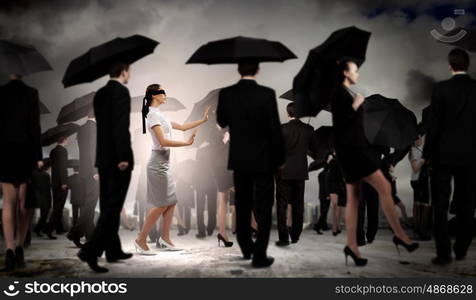 Businesswoman in blindfold among group of people. Image of businesswoman in blindfold walking among group of people