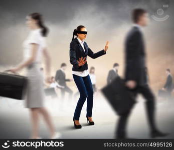 Businesswoman in blindfold among group of people. Image of businesswoman in blindfold walking among group of people