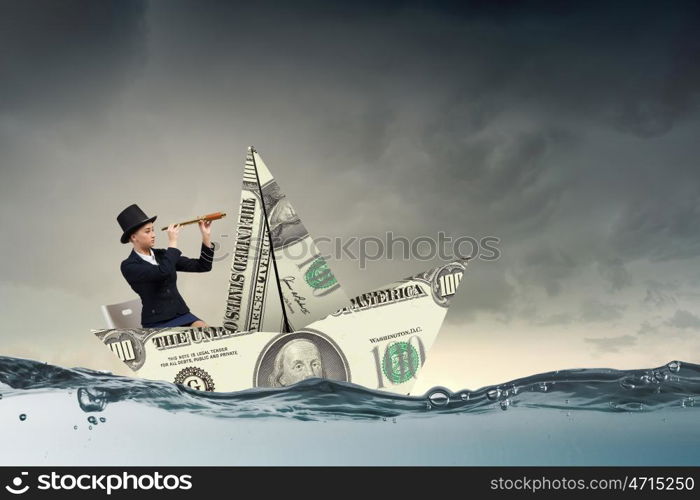 Businesswoman in boat made of dollar banknote. Successful businesswoman sailing on dollar boat in financial sea