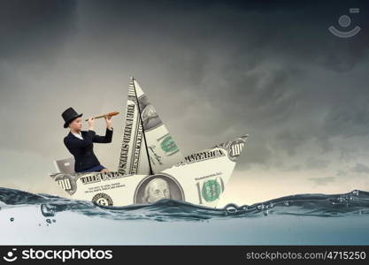 Businesswoman in boat made of dollar banknote. Successful businesswoman sailing on dollar boat in financial sea