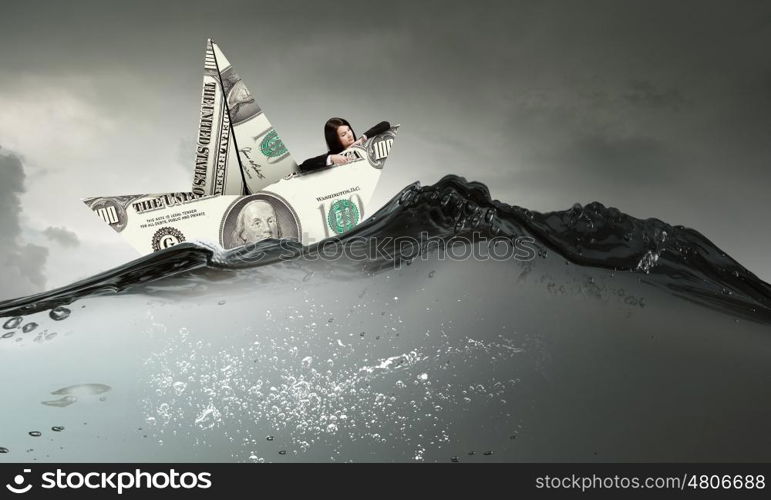 Businesswoman in boat made of dollar banknote. Successful businesswoman sailing on dollar boat in financial sea