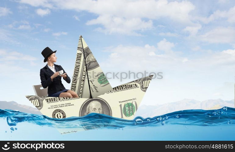 Businesswoman in boat made of dollar banknote. Successful businesswoman sailing on dollar boat in financial sea