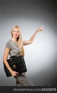 Businesswoman in business concept with briefcase