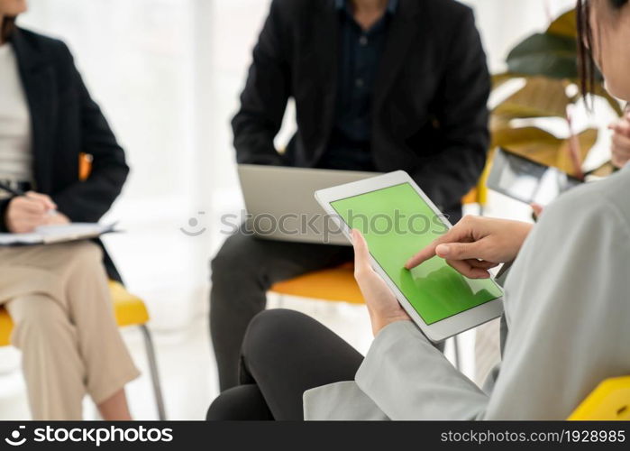 Businesswoman in business meeting using computer proficiently at office room . Corporate business team collaboration concept .. Businesswoman in business meeting using computer proficiently at office room .