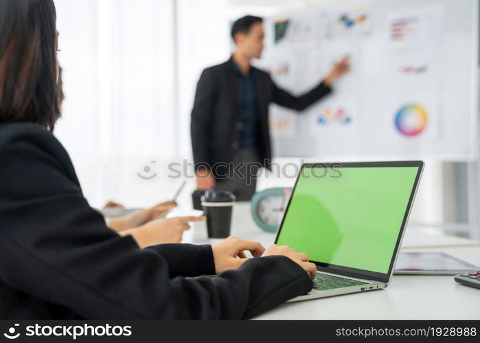 Businesswoman in business meeting using computer proficiently at office room . Corporate business team collaboration concept .. Businesswoman in business meeting using computer proficiently at office room .