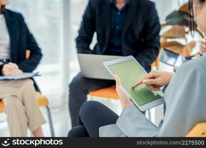 Businesswoman in business meeting using computer proficiently at office room . Corporate business team collaboration concept .. Businesswoman in business meeting using computer proficiently at office room .