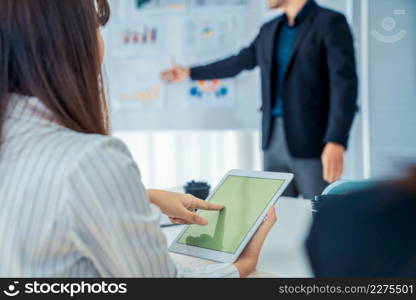 Businesswoman in business meeting using computer proficiently at office room . Corporate business team collaboration concept .. Businesswoman in business meeting using computer proficiently at office room .