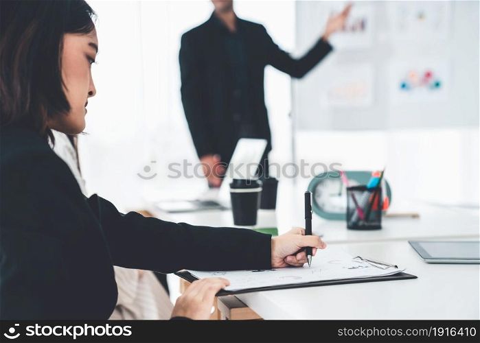Businesswoman in business meeting writing paper proficiently at office room . Corporate business team collaboration. Businesswoman in business meeting writing paper proficiently at office room .
