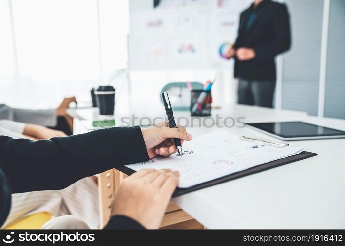 Businesswoman in business meeting writing paper proficiently at office room . Corporate business team collaboration. Businesswoman in business meeting writing paper proficiently at office room .