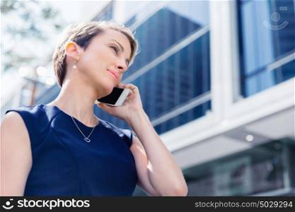 Businesswoman in city holding her mobile. Technology is a part of my life