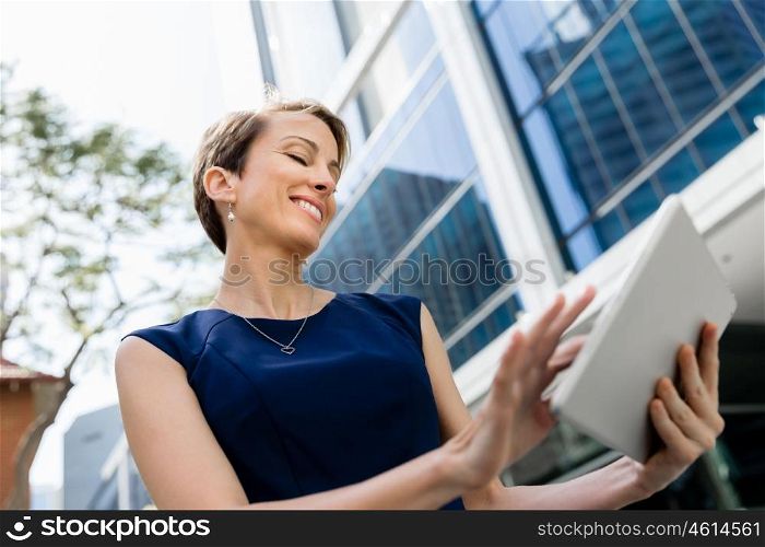 Businesswoman in city holding his notebook. Technology is a part of my life