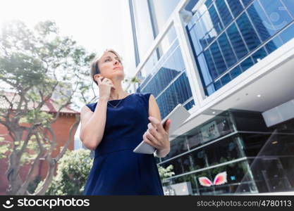 Businesswoman in city holding his notebook. Technology is a part of my life