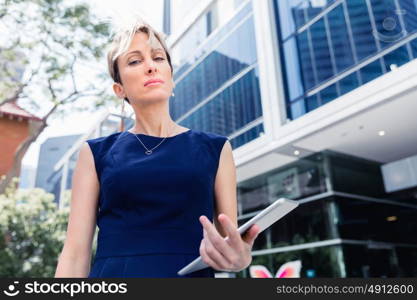 Businesswoman in city holding his notebook. Technology is a part of my life