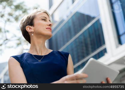 Businesswoman in city holding his notebook. Technology is a part of my life