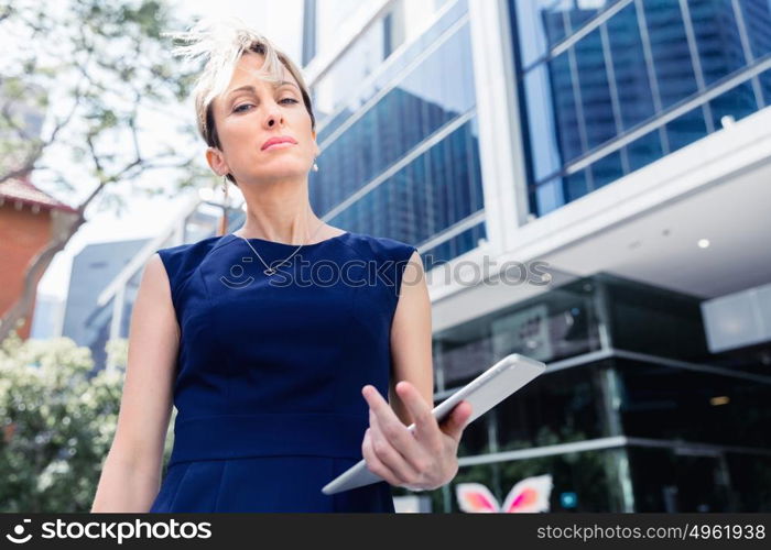 Businesswoman in city holding his notebook. Technology is a part of my life