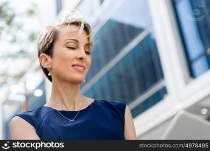 Businesswoman in city holding his notebook. Technology is a part of my life