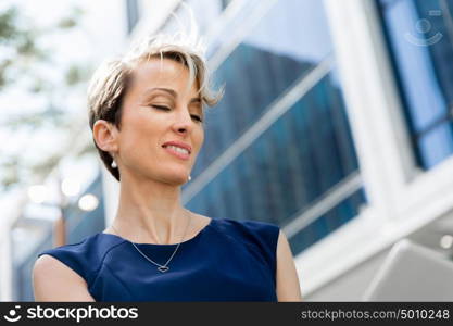 Businesswoman in city holding his notebook. Technology is a part of my life