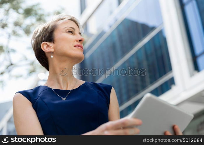 Businesswoman in city holding his notebook. Technology is a part of my life