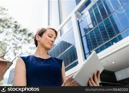 Businesswoman in city holding his notebook. Technology is a part of my life