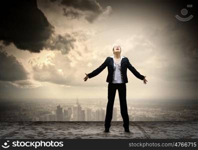 Businesswoman in despair. Image of businesswoman on top of building screaming