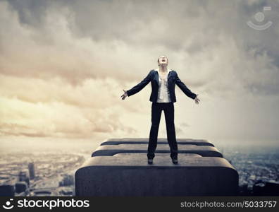 Businesswoman in despair. Image of businesswoman on top of building screaming