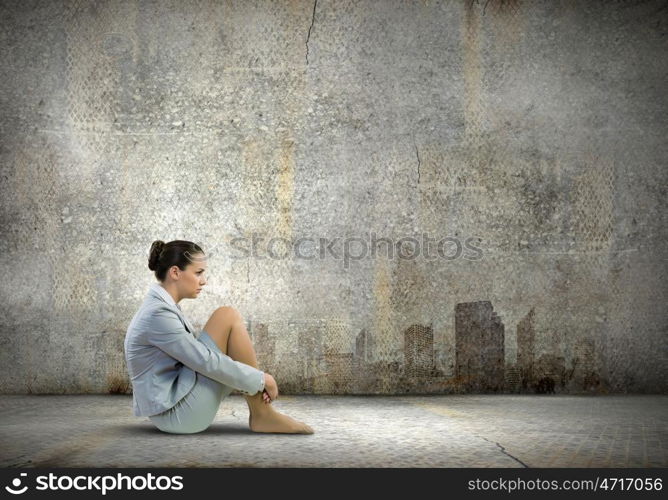 Businesswoman in despair. Image of young upset businesswoman sitting alone