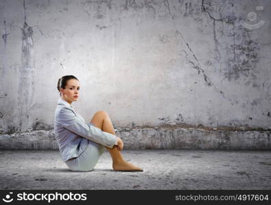 Businesswoman in despair. Image of young upset businesswoman sitting alone